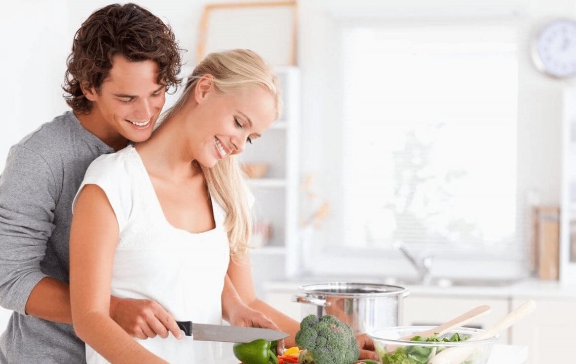 A young couple cooking